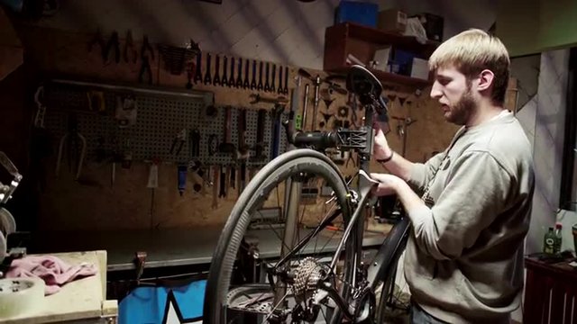 Mechanic preparing bicycle for repairing. Slider shoot