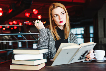 Pretty girl with short hair and red lips in cafe