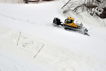 Yellow ratrak works in mountains