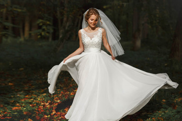 luxury stylish young bride on the background  spring sunny green