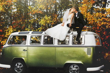 merry happy young couple on the background fabulous autumn fores