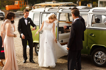 сute stylish luxury bride and groom on the background retro car