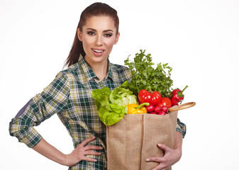 Isolated woman holding a shopping bag full of vegetables