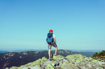 Rear view of man standing on the top of rock