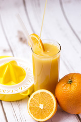 Fresh orange juice in glass with sliced orange