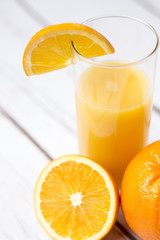 Fresh orange juice in glass with sliced orange