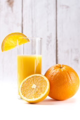Fresh orange juice in glass with sliced orange