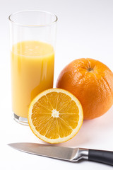 Fresh orange juice in glass with sliced orange