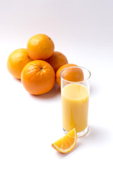 Fresh orange juice in glass with sliced orange