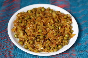 Indian patta goghi-muttar Sabji (cabbage and green pea vegetable) in white plate