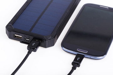 Portable solar charger for smart phone. © garry_images