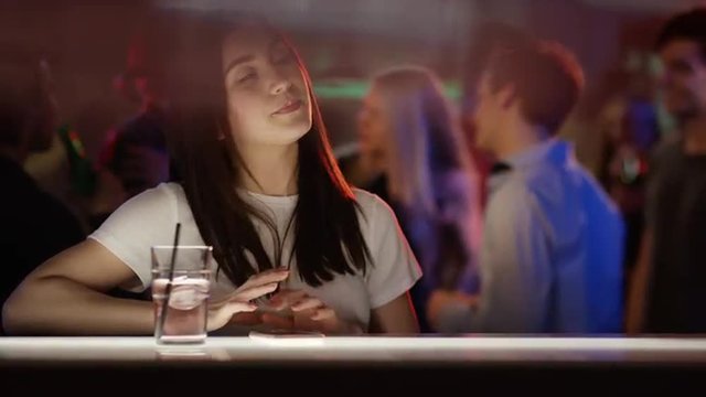 Beautiful girl alone at bar