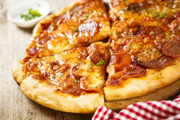 Meat pizza with cheese and herbs