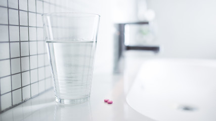Tablets are on the table in the bathroom