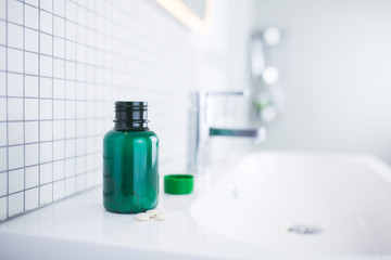 pill bottle standing in the bathroom
