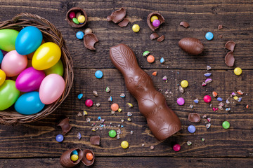 Fototapeta na wymiar Chocolate easter eggs and sweets on wooden background