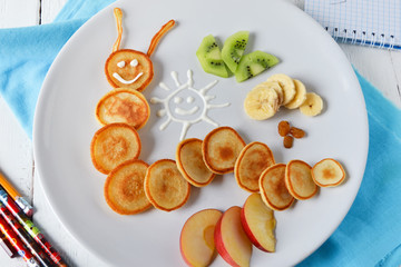 caterpillar of pancakes with fruit for breakfast