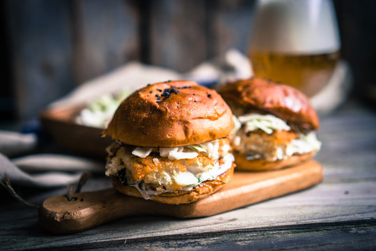 Rustic fish burgers with coleslaw and beer