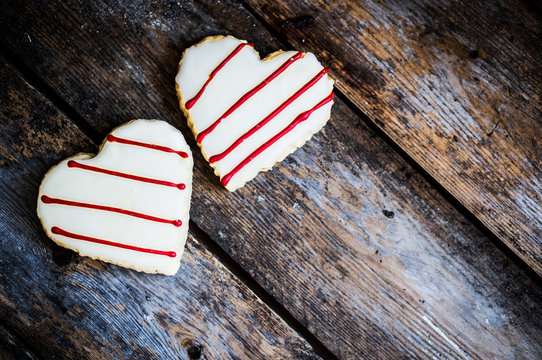 White And Red Heart Cookies On Rustic Wooden Background