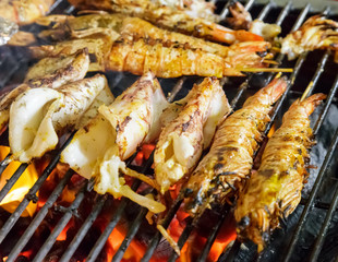 Grilled squid stuffed with seafood by fire and BBQ Flames.