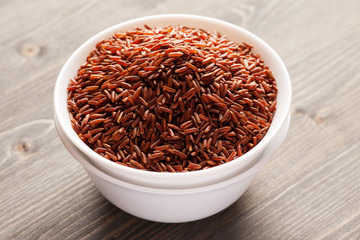 Fototapeta na wymiar Red rice in two stacked ceramic bowls