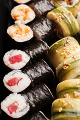 Sushi rolls with salmon in black seaweed