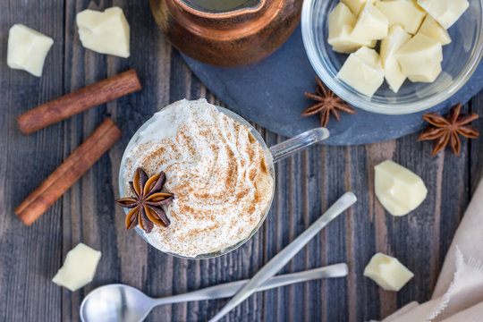 Hot white chocolate, decorated with whipped cream and cinnamon, top view