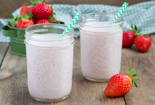 Healthy smoothie with strawberry, banana and yogurt in glass jar