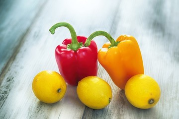 Bell pepper and  lemons on the wooden background