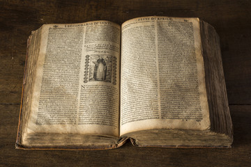 Open old book on wooden table