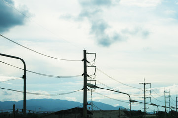 Electricity posts  with blue sky, in silhouette