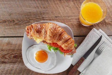 sandwich with fried bacon cheese tomato croissant