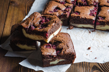 Raspberry brownie on wooden background