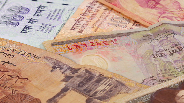 Different asian currency bank notes rotating and panning business background