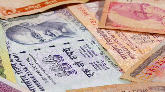 Different asian currency bank notes rotating and panning business background