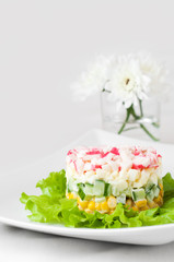 Crab sticks salad on white tablecloth