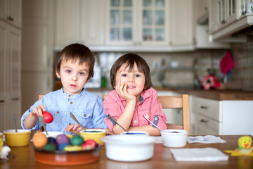 Two boys, coloring eggs for Easter