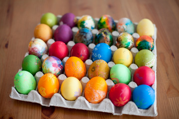 Fototapeta na wymiar Colorful easter eggs in bowl on rustic wooden background