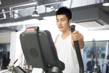 young man working out in modern gym