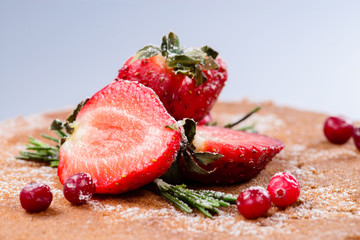 closeup decoration fresh strawberries and cranberries on the san