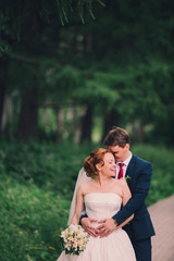 Bride smile when groom hugs her