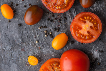 Fototapeta na wymiar Tomatoes mix with seasoning on the stone table horizontal