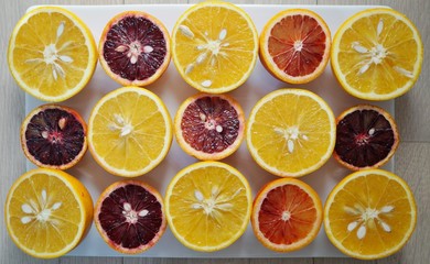 Ruby red blood oranges and navel oranges cut in half 