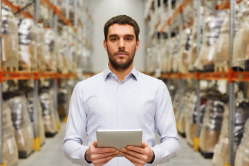 businessman with tablet pc at warehouse