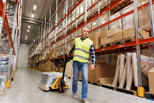 man carrying loader with goods at warehouse