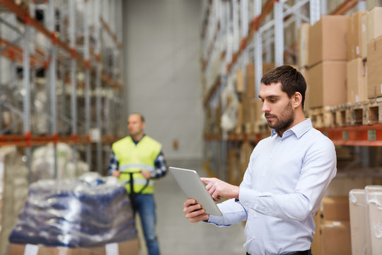 businessman with tablet pc at warehouse