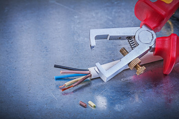 Insulation strippers electrical wires on scratched metallic back