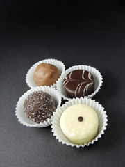 Chocolates, isolated on black. Chocolate truffles, arrangement.   