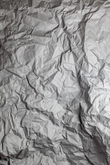 Dark grey crumpled paper background vertical composition