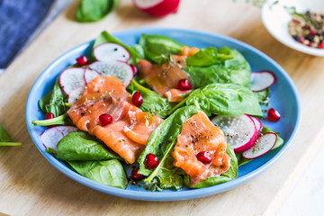 Salmon with spinach and pomegranate  salad